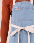 Close up of light wash Full Indigo Denim Apron on Isaac