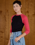Angled side view of the Black/Pink Colorblock Raglan Tee