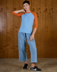 Alex wearing the the Baby Blue/Orange Colorblock Raglan Tee untucked with the Light Wash Denim Drop Pocket Pants