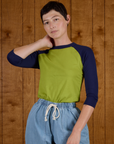 Alex wearing the Gross Green/Navy Colorblock Raglan Tee tucked into the Light Wash Denim Drop Pocket Pants