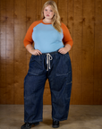 Juliet is wearing the Baby Blue/Orange Colorblock Raglan Tee tucked into the Dark Wash Denim Drop Pocket Pants