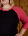 Close up of the the Black/Pink Colorblock Raglan Tee's sleeve on Juliet