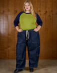 Juliet wearing the Gross Green/Navy Colorblock Raglan Tee tucked into the Dark Wash Denim Drop Pocket Pants
