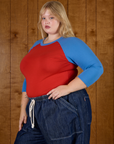Angled side view of the Mustang Red/Blue Colorblock Raglan Tee on Juliet