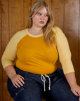 Juliet is 5'7" and wearing L Mustard Yellow/Butter Raglan Tee