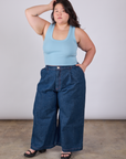 Ashley is wearing Cropped Tank Top in Baby Blue and dark wash Indigo Wide Leg Trousers