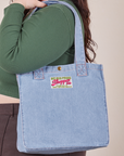 Denim Shopper Tote Bag in Light Wash worn on model's shoulder