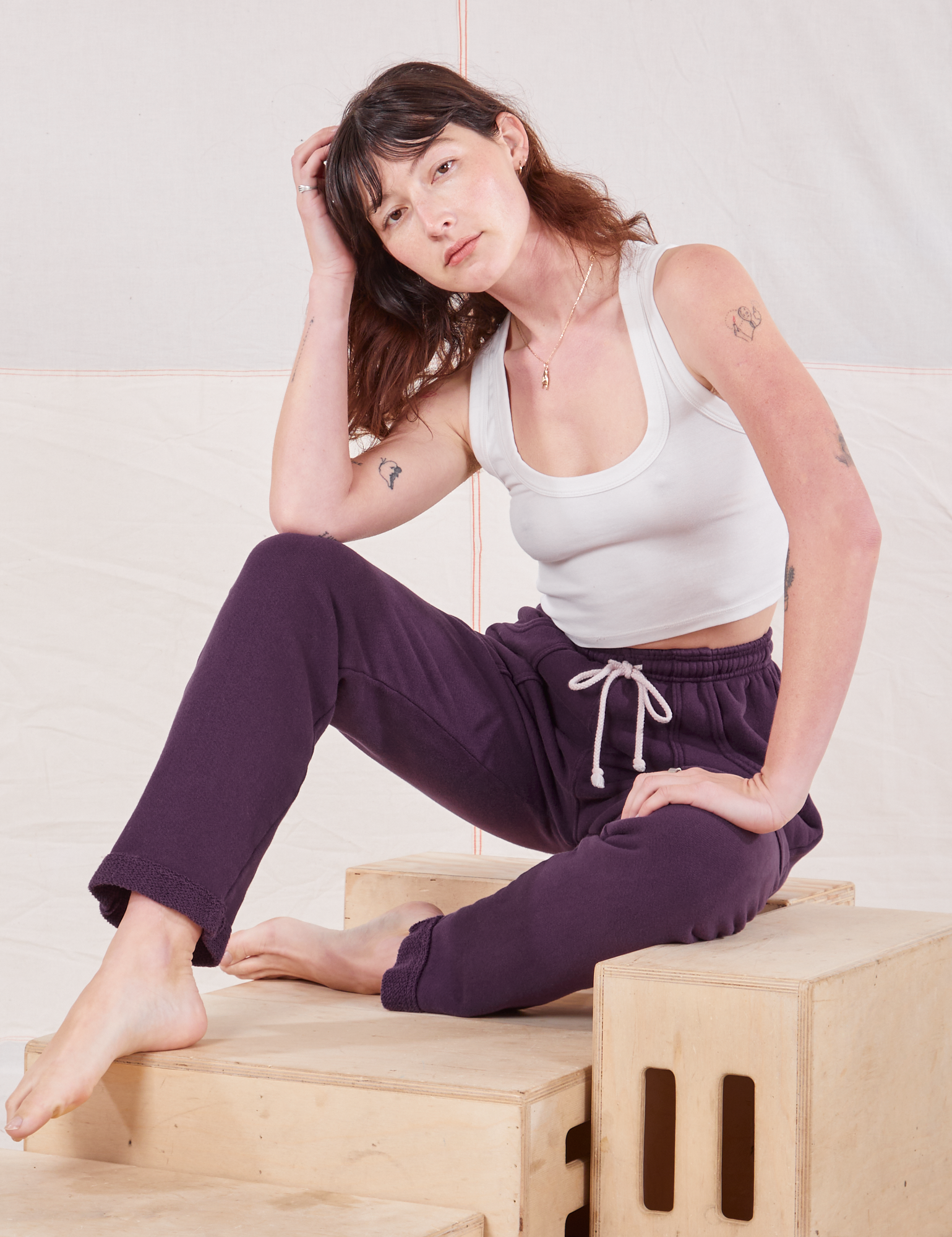 Alex is wearing Rolled Cuff Sweat Pants in Nebula Purple and vintage off-white Cropped Tank