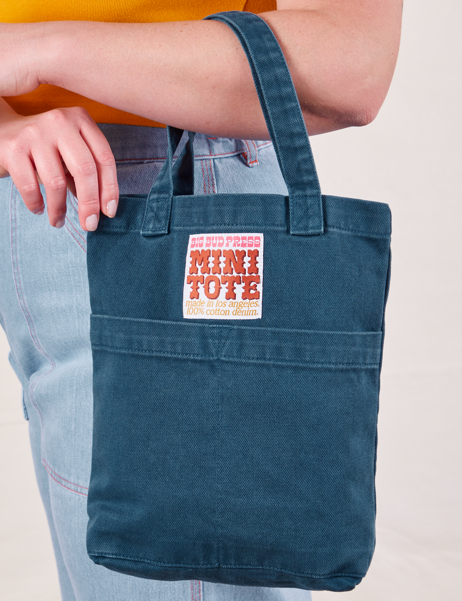Mini Tote Bag in Lagoon worn on arm of model