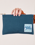 Perfect Pencil Pouch in Lagoon held at the top by model