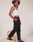 Side view of Long Heavyweight Trousers Basic Black and Cropped Cami in vintage tee off-white on Jerrod