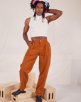 Jerrod is 6'3" and wearing S Long Heavyweight Trousers in Burnt Terracotta paired with Sleeveless Turtleneck in vintage tee off-white