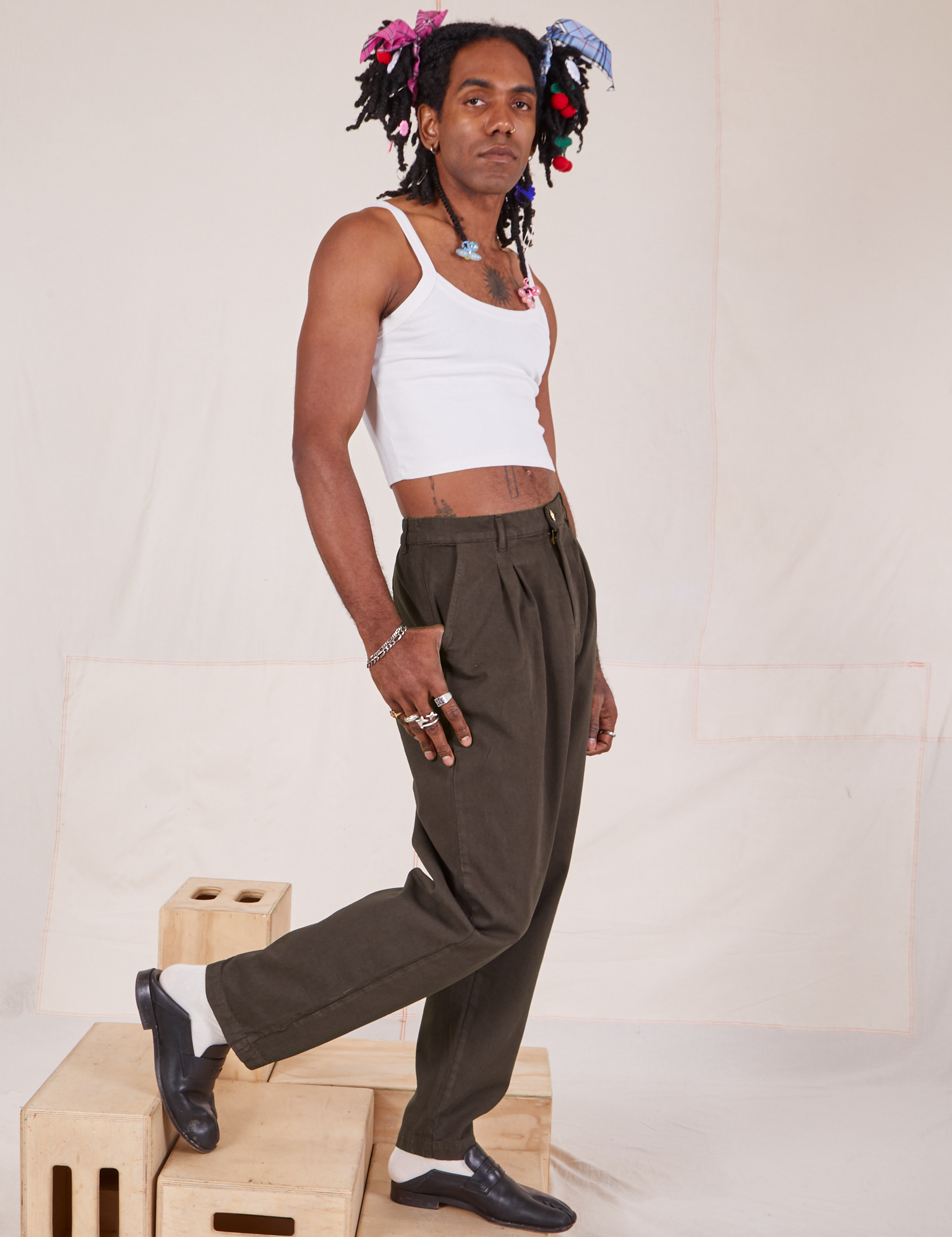 Side view of Heavyweight Trousers in Espresso Brown and Cropped Cami in vintage tee off-white on Jerrod