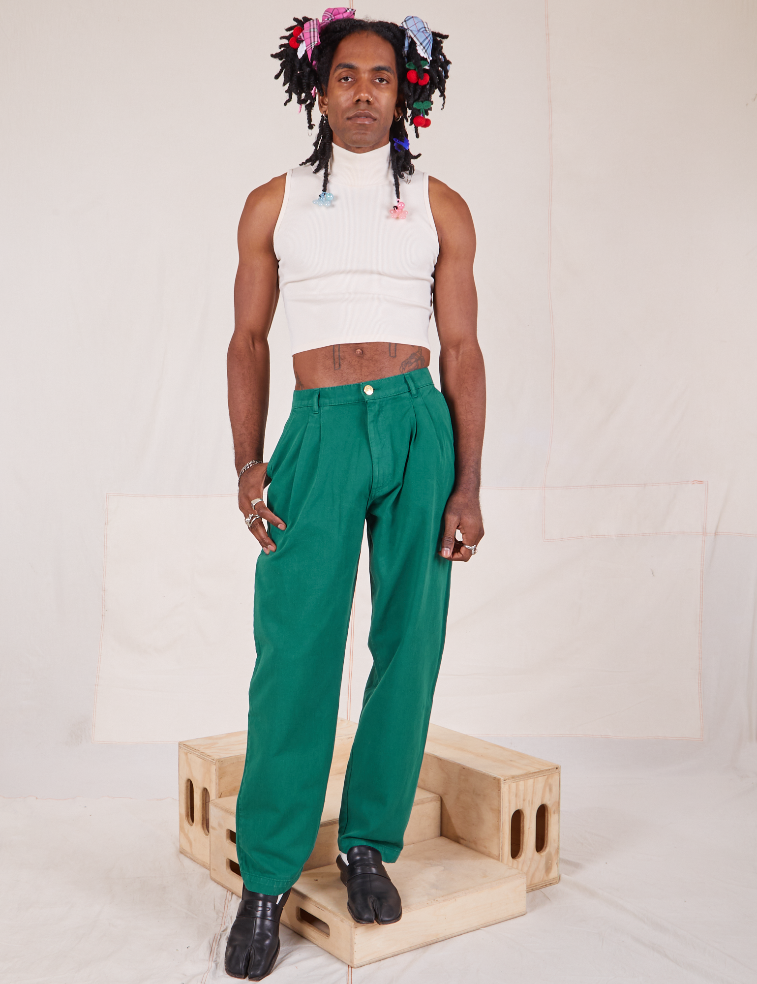 Jerrod is 6&#39;3&quot; and wearing S Long Heavyweight Trousers in Hunter Green paired with Sleeveless Turtleneck in vintage tee off-white