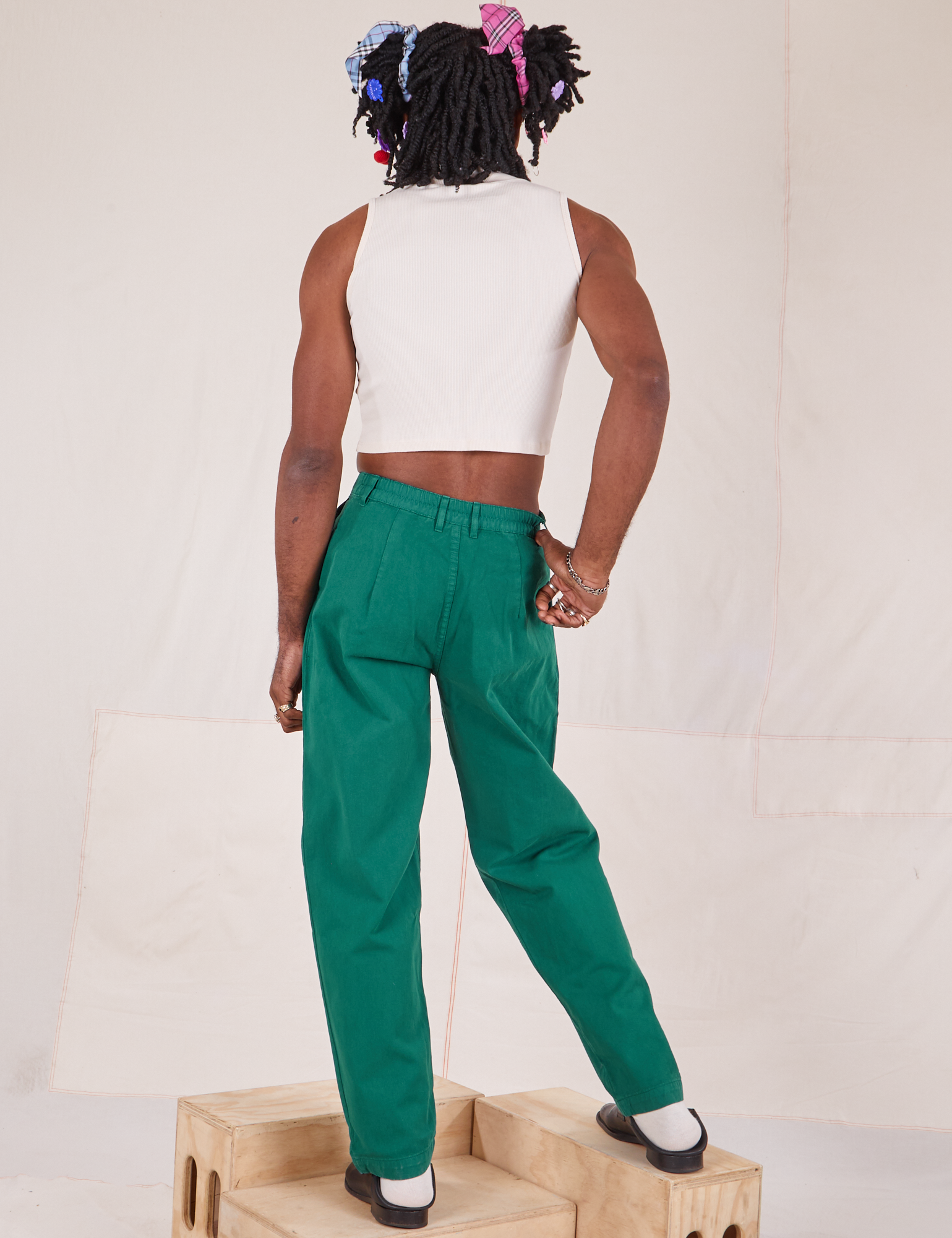 Back view of Heavyweight Trousers in Hunter Green and Sleeveless Turtleneck in vintage tee off-white on Jerrod