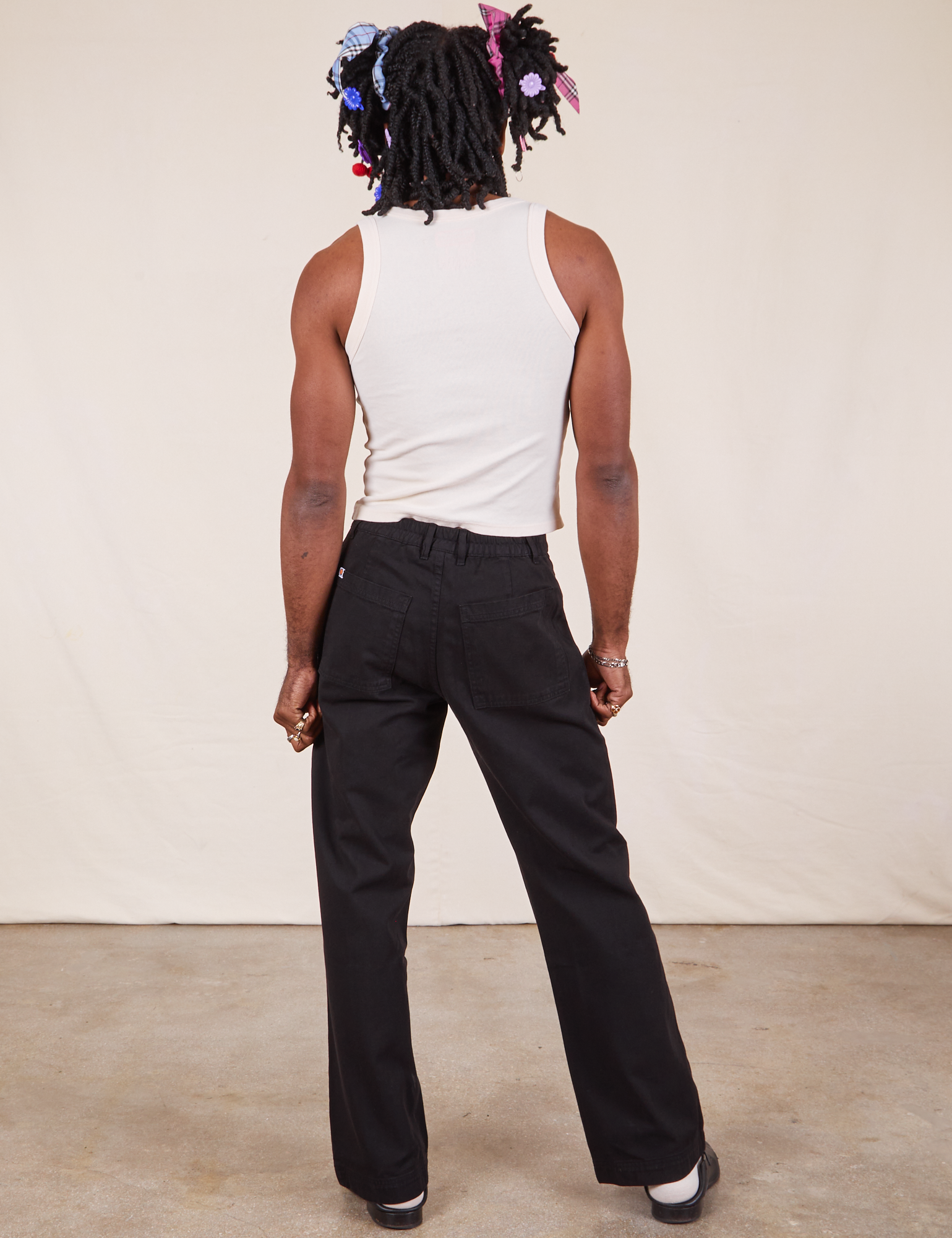 Back view of Western Pants in Basic Black and Tank Top in vintage tee off-white on Jerrod