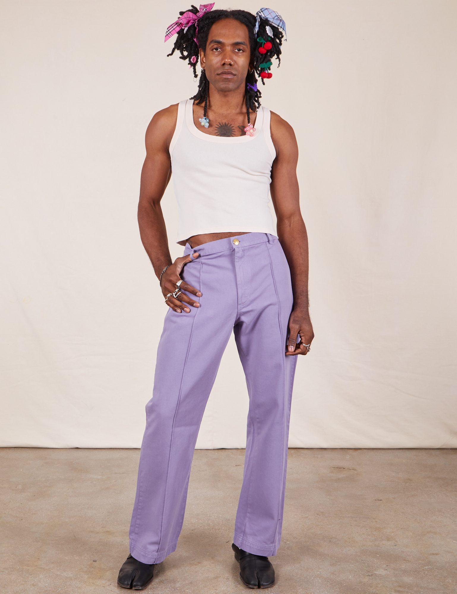 Jerrod is 6&#39;3&quot; and wearing M Long Western Pants in Faded Grape paired with Tank Top in vintage tee off-white