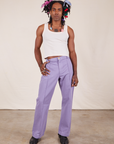 Jerrod is 6'3" and wearing M Long Western Pants in Faded Grape paired with Tank Top in vintage tee off-white