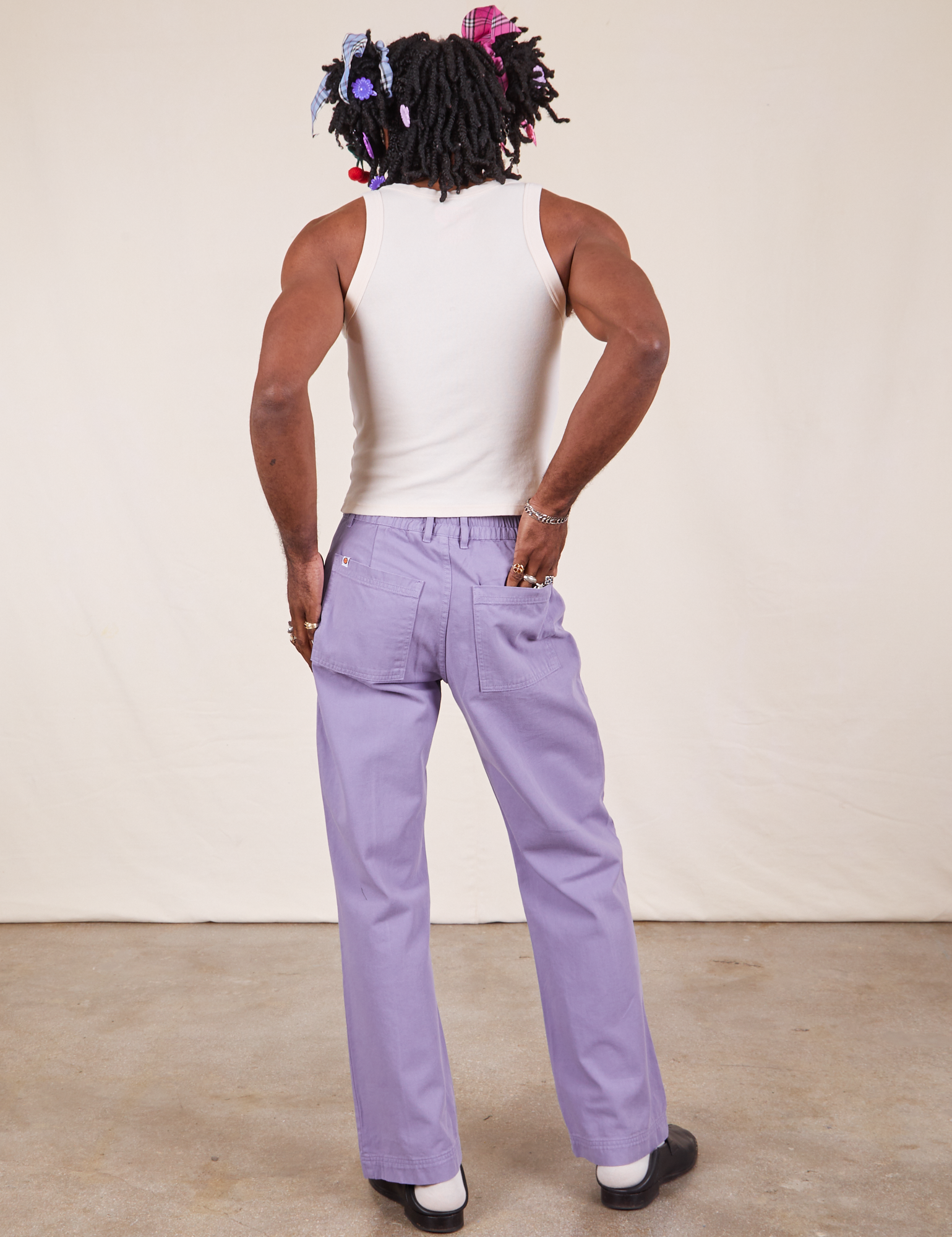 Back view of Western Pants in Faded Grape and vintage off-white Tank Top on Jerrod