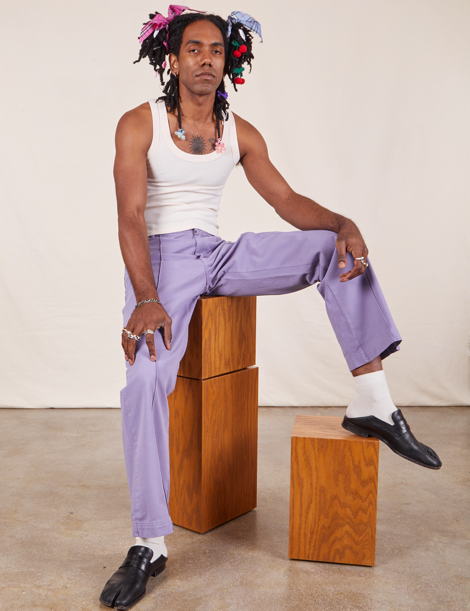 Jerrod is wearing Western Pants in Faded Grape and Tank Top in vintage tee off-white