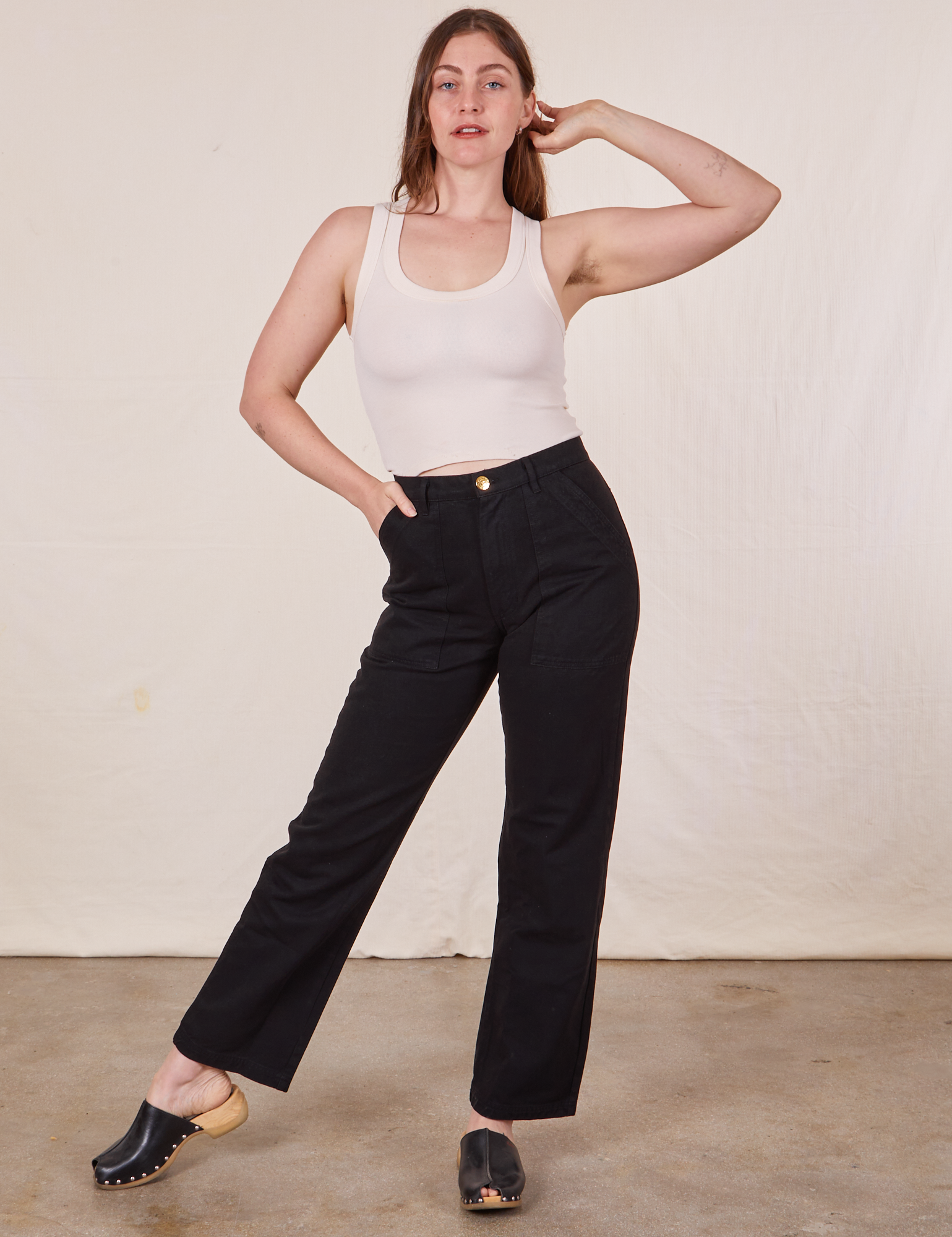 Allison is 5&#39;10&quot; and wearing Long S Work Pants in Basic Black paired with vintage off-white Tank Top