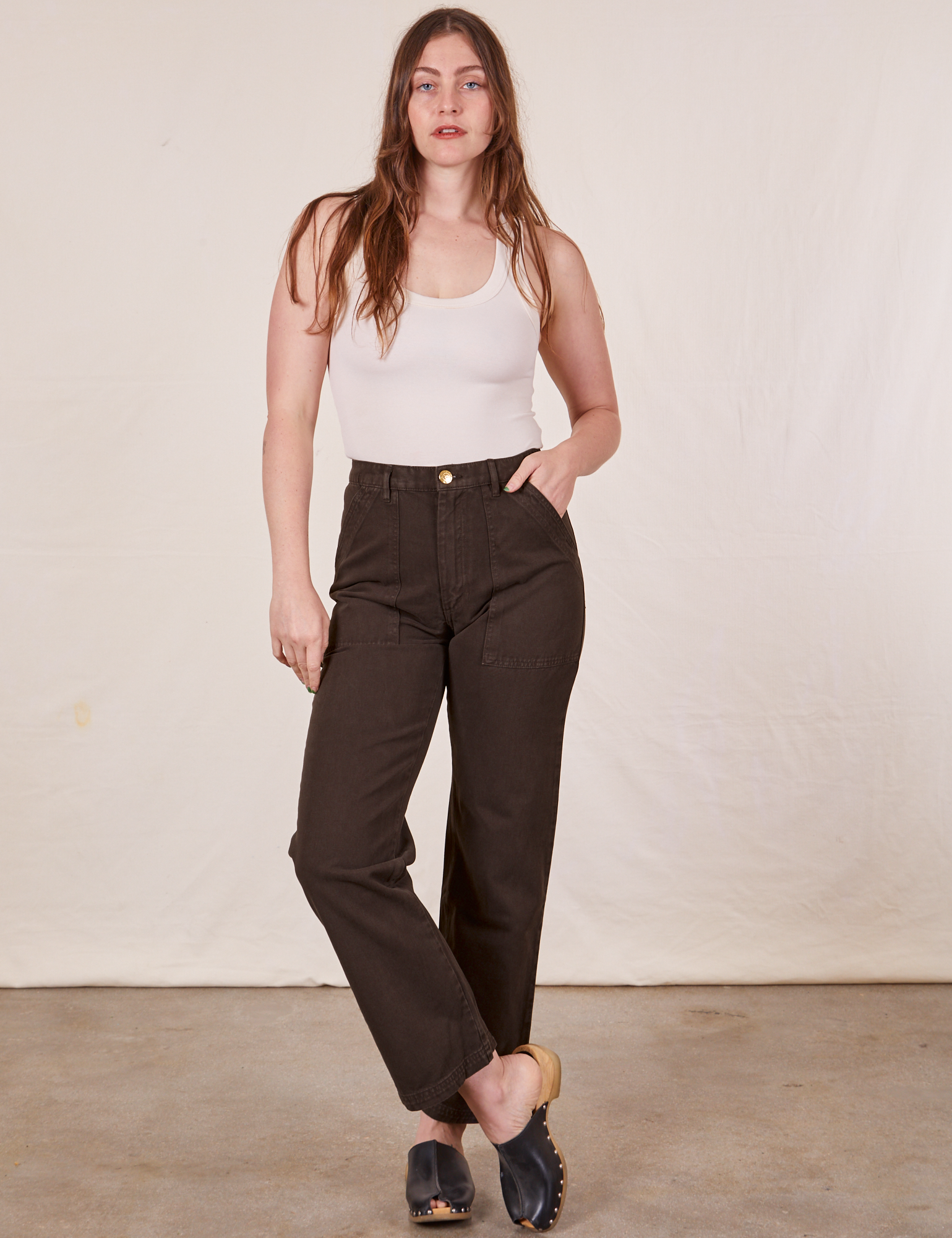 Allison is 5&#39;10&quot; and wearing Long S Work Pants in Espresso Brown paired with a Tank Top in vintage tee off-white