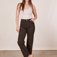 Allison is 5'10" and wearing Long S Work Pants in Espresso Brown paired with a vintage off-white Tank Top