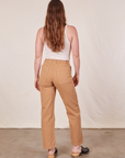 back view of Long Work Pants in Tan and Tank Top in vintage tee off-white worn by Allison