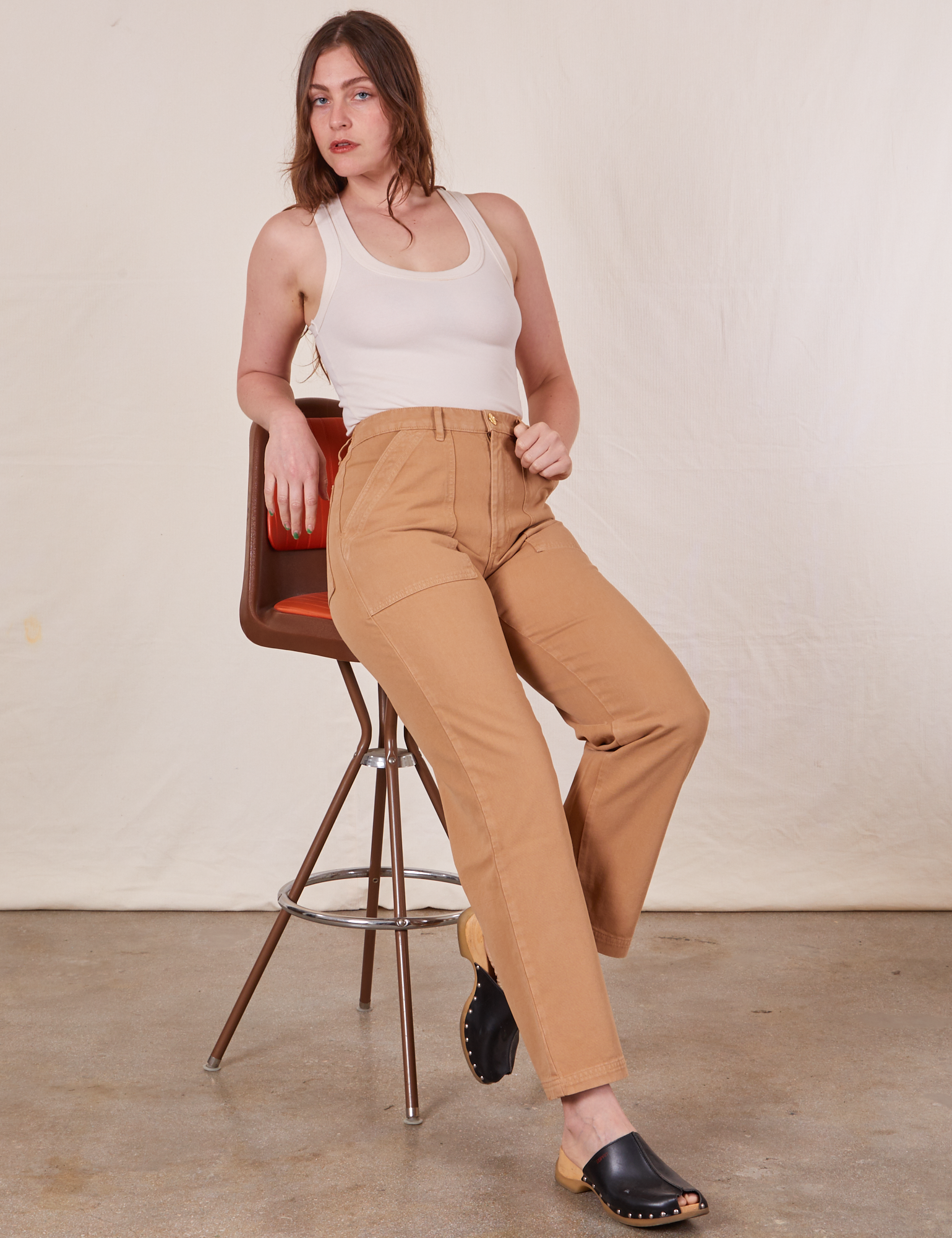 Allison is 5&#39;10&quot; and wearing S Long Work Pants in Tan and Tank Top in vintage tee off-white