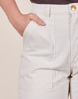Front pocket close up of Work Pants in Vintage Tee Off-White. Worn by Allison with her hand in the pocket.