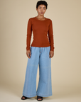 Mika in the Burnt Terracotta Long Sleeve Baby Tee and Petite Light Wash Wide Leg Denim Trousers