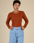 Mika wearing the Burnt Terracotta Long Sleeve Baby Tee tucked in