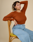 Tiara wearing the Burnt Terracotta Long Sleeve Baby Tee