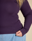 Close up of the hem on the Nebula Long Sleeve Baby Tee worn by Juliet