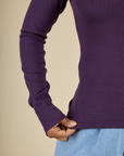 Close up of the hem on the Nebula Long Sleeve Baby Tee worn by Mika