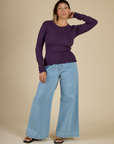 Tiara wearing the Nebula Long Sleeve Baby Tee with Light Wash Wide Leg Denim Trousers