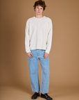 Quinn wearing the Vintage Tee White Long Sleeve Burly Tee with Light Wash Carpenter Jeans