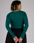 Back view of Tiara in the Hunter Green Long Sleeve Porthole Tee