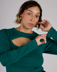 Tiara is 5'4" and wearing XS Hunter Green Long Sleeve Porthole Tee