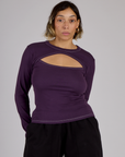 Tiara is 5'4" and wearing XS Nebula Purple Long Sleeve Porthole Tee