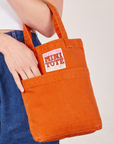 Mini Tote Bag in Burnt Orange on Alex's arm