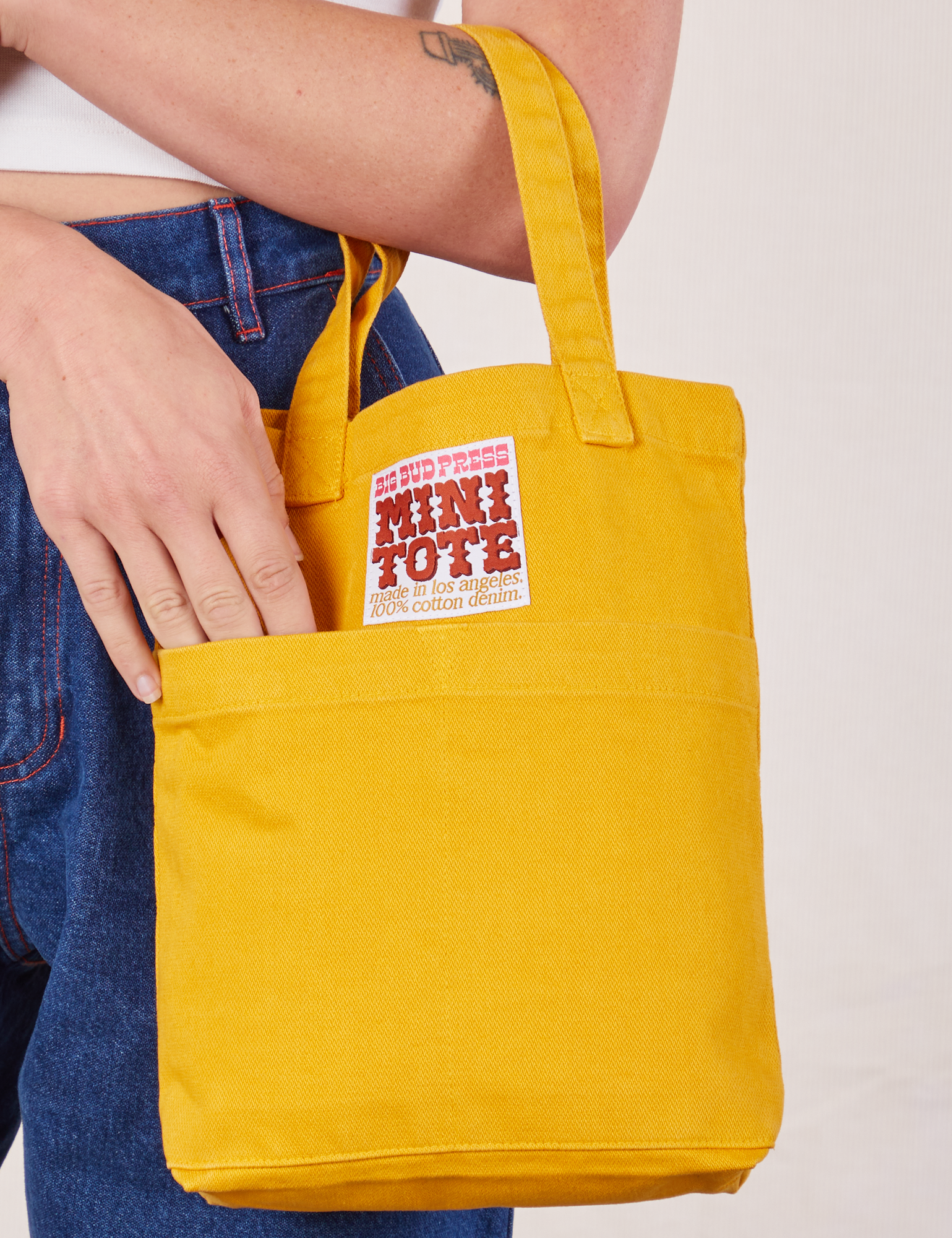 Mini Tote Bag in Mustard Yellow on Alex's arm