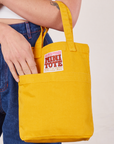 Mini Tote Bag in Mustard Yellow on Alex's arm