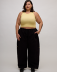 Kristen is wearing the Butter Yellow Deep Cut Racerback with Black Drop Pocket Pants