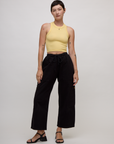 Alex wearing the Butter Yellow Deep Cut Racerback with the Black Drop Pocket Cargo Pant