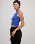 Side view of Alex in the Cornflower Blue Deep Cut Racerback