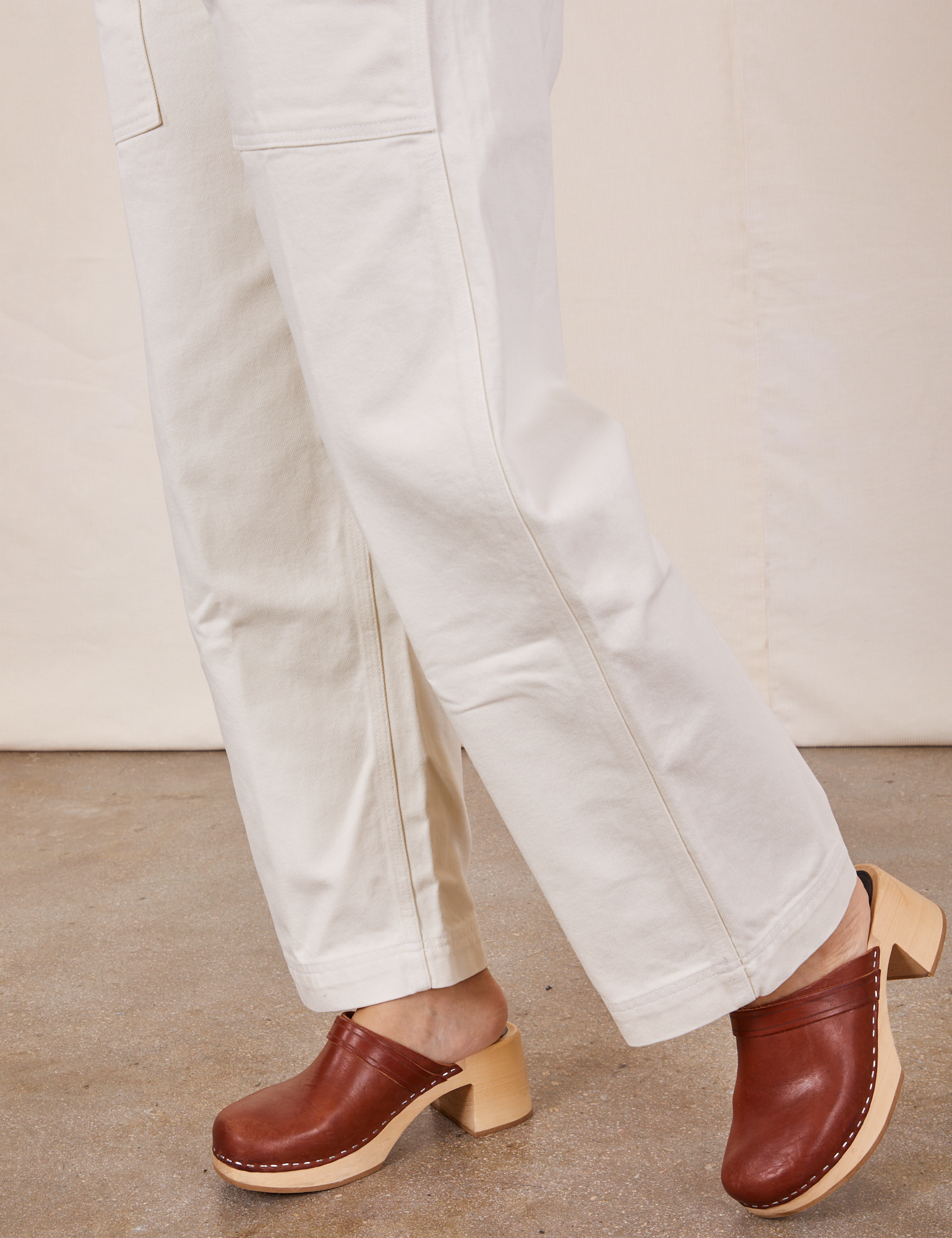 Side view pant leg close up of Original Overalls in Vintage Tee Off-White on Tiara