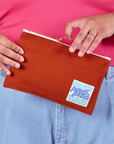 Model is holding a Pencil Pouch in Paprika Red