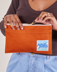 Pencil Pouch in Burnt Orange held by model