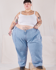 Jordan is 5'4" and wearing 6XL Petite Carpenter Jeans in Light Wash paired with vintage off-white Cami